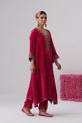 Rani Pink zardozi embroidered velvet kurta paired with red velvet pants and embroidered organza silk dupatta