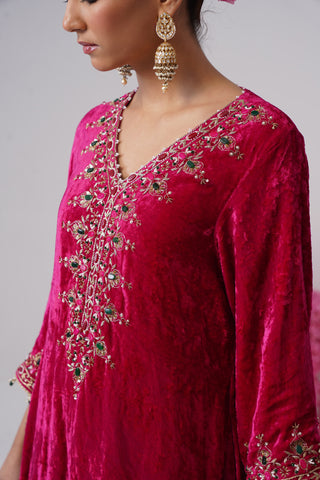Rani Pink zardozi embroidered velvet kurta paired with red velvet pants and embroidered organza silk dupatta