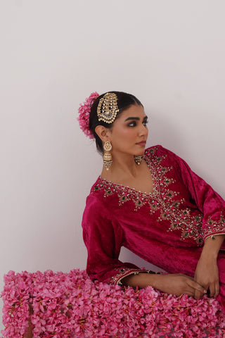 Rani Pink zardozi embroidered velvet kurta paired with red velvet pants and embroidered organza silk dupatta