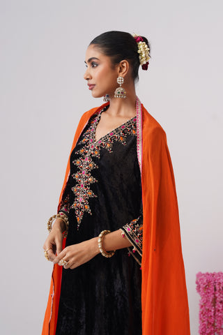Black zardozi embroidered velvet kurta paired with rani pink velvet pants and embroidered organza silk dupatta